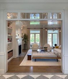 a living room filled with furniture and lots of windows