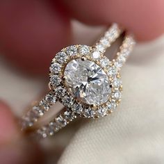 a close up view of a diamond ring on someone's finger