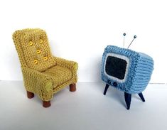 two knitted chairs sitting next to each other in front of a white wall with a television on it