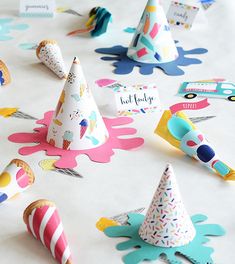 colorful party hats are scattered on a table