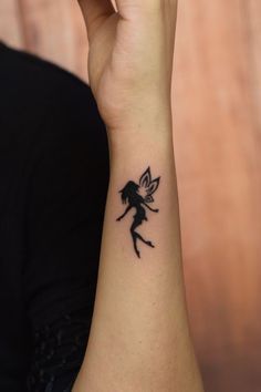 a woman with a small tattoo on her wrist