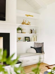 a living room filled with furniture and a flat screen tv mounted on a wall next to a fire place