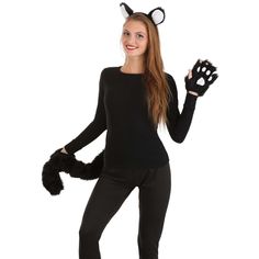 a woman wearing a cat costume and holding a black furry animal paw glove in front of her face