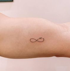 a tattoo on the arm of a woman with an infinite sign in it's center