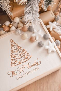 a christmas tree is on the table next to other decorations and gifts that are wrapped in brown paper