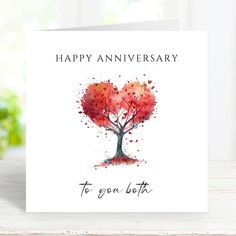 a happy anniversary card with an image of a tree in the shape of a heart