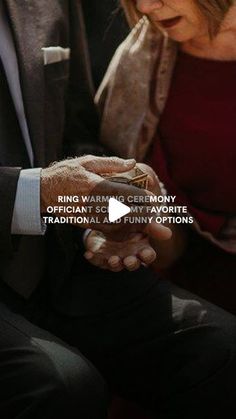 a man and woman are looking at something on their cell phone while sitting next to each other