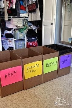 three cardboard boxes with post - it notes on them sitting in front of a closet