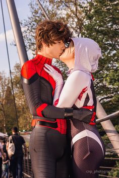 two people dressed as spider - man kissing each other