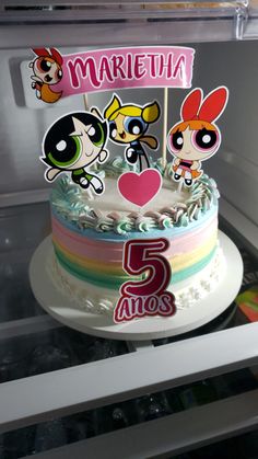 there is a birthday cake with cartoon characters on it and the number five in front