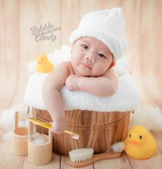 a baby in a bath tub surrounded by rubber ducks and soapy water with toothbrushes