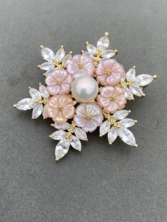 Stunning flower shaped genuine freshwater pearl brooch/pendent Metal is bronze with yellow gold plate 100% hand made Decorate with pink flowers carved out of mother pearls It looks so luxury and the details are so nice In the middle is a big nice freshwater pearl It comes with brand box and good for gifting It is brand new with price tag on. (tag price 1700 Danish Krone) international shipping from 20 days to 3 months to USA Most of the times, it arrived within 25 days, but sometimes it could be Flower Pendant Brooch For Wedding, Wedding Jewelry: Flower Pendant Brooch, Gold Flower-shaped Brooches For Gifts, Gold Flower-shaped Brooch For Gift, Gold Flower Shaped Brooch As Gift, Gold Flower Shaped Brooch For Gift, Pink Flower Brooch For Gift, Pink Brooch Jewelry For Wedding, Pink Wedding Brooch Jewelry