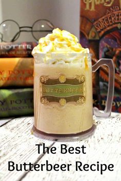 the best butterbeeer recipe is in a glass mug on a table next to some books