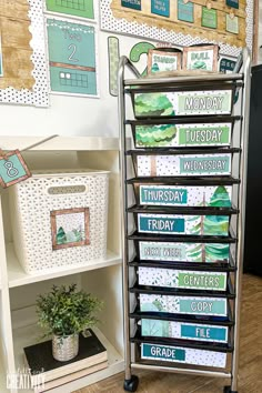 a display case with several cards on it in front of a bulletin board and bookshelf