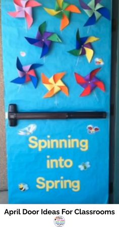 a blue door decorated with colorful paper birds and the words spring into spring written on it