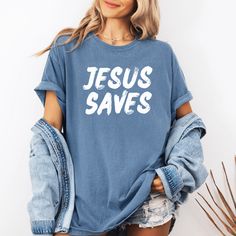 This Jesus Saves Shirt is the perfect way to share a bold faith statement with others in a fashion-forward way. This trendy Christian graphic tee with bold message that Jesus saves, is sure to turn heads! It's the perfect combination of faith and fashion to create a trendy Christian street style or casual chic outfit that makes a bold statement! Wearing Christian apparel like this Jesus tee, is an intentional way to proclaim your faith and create opportunities to share Jesus with others. If you’ Cotton T-shirt With Faith Text Print, Inspirational Letter Print T-shirt For Spring, Inspirational Text Print Tops With Relaxed Fit, Inspirational Text Print Relaxed Fit Top, Inspirational Text Print Tops In Relaxed Fit, Inspirational Relaxed Fit Tops For Streetwear, Inspirational Text Print Top With Relaxed Fit, Relaxed Fit Inspirational Shirt With Graphic Print, Inspirational Relaxed Fit Shirt With Graphic Print