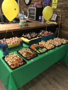 a green table topped with lots of food