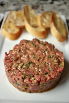 a plate with some bread and meat on it