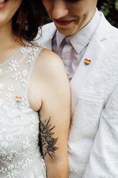 a man and woman with tattoos on their arms