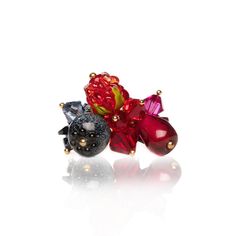 "Behold the enchanting allure of our handcrafted glass berries and Austrian crystal ring, a delicate masterpiece that exudes natural charm. This exquisite piece showcases lifelike blueberries, raspberries, and pomegranate seeds meticulously crafted through the art of lampwork. The sweet berries elegantly dance upon a gold-plated ring, basking in the shimmering sparkle emanating from meticulously placed Austrian crystals. Each berry becomes a radiant focal point, surrounded by a vibrant rainbow of corresponding Austrian crystals, creating a harmonious and captivating display. This ring is not just an accessory; it's a wearable celebration of nature's beauty, crafted with precision and adorned with the brilliance of summery crystals. Style R010 Materials: - 24-karat gold-plated brass adjusta Glass Roses, Summer Tropical, Handmade Lamps, Rainbow Bracelet, Etsy Bridesmaid Gifts, Pomegranate Seeds, Crystal Ring, Tropical Fruit, Gold Plated Rings