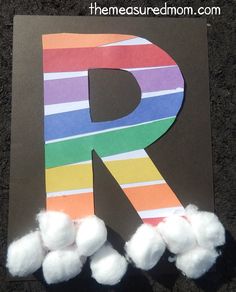 the letter r is made out of paper and pom - poms