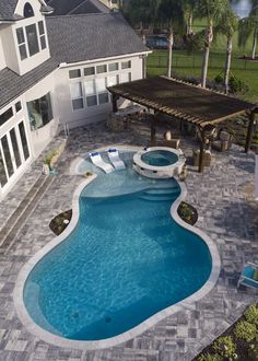 an above ground swimming pool surrounded by landscaping