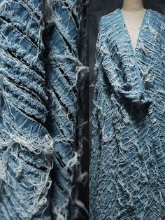 two pieces of clothing that are covered in blue yarn and frayed up with fringes