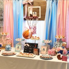 a table topped with lots of desserts and basketball themed items on top of it