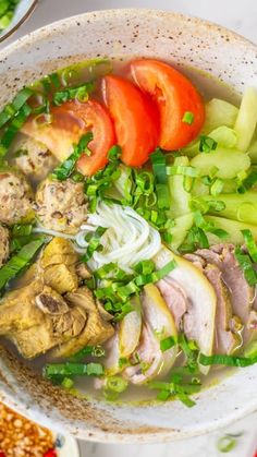 a bowl filled with meat and vegetables on top of a table