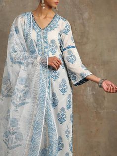 Set of 3 consists of kurta, dupatta and salwar Hand-printed poppies in shades of blue set on an ivory base. Straight v neck, bell sleeve kurta in cotton with hand-made magzi and gota detailing. Salwar- Cotton salwar set in a contrast blue with lehriya gota work Dupatta- Handwoven kota doria, block printed dupatta. Colour - Blue Fabric - Cotton and Kota Doria Occasion - Festive Wear / Occasion Wear Fit - Straight, Relaxed and Comfortable Pattern - Printed Care - Dry Clean only Estimated Delivery