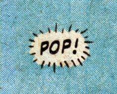 the word pop is painted on a piece of blue fabric