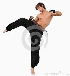 a shirtless man doing karate