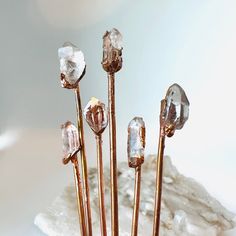 "Raw Quartz Crystal Hair Sticks are back by POPULAR demand and this time we have more purchase options! Using crystals unearthed by myself and my family, I chose the best water clear crystals to make these dainty boho beauties for your hair.   Whether you're a mermaid looking for the perfect dinglehopper, a Healer that needs some good vibes, or a shopper who loves to stand out....my creation is for you! 😊   ✨ Approximately 4\" Tall and .25\" Wide Set of Two= 2 hair sticks Set of Three=3 hair sticks Set of Four=4 hair sticks Set of Five= 5 hair sticks Need something thicker? Check these out!  https://www.etsy.com/BinkStudio/listing/1283948217/raw-crystal-hair-stick-ready-to-ship?utm_source=Copy&utm_medium=ListingManager&utm_campaign=Share&utm_term=so.lmsm&share_time=1660170673466   About B Opal Hair, Using Crystals, Crystal Hair Accessories, Crystal Hair Clips, Raw Quartz Crystal, Boho Crystal, Crystal Hair Pins, Electroformed Jewelry, Raw Quartz