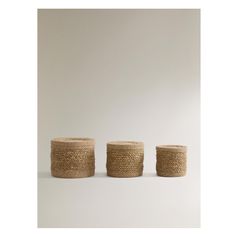 three woven baskets sitting next to each other