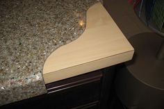 a close up of a wooden cutting board on a counter