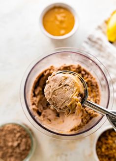 an ice cream scooping out of a bowl with chocolate and peanut butter in it