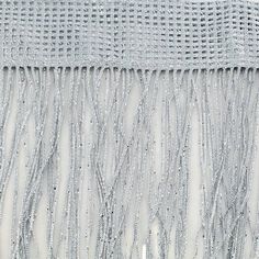 silver beaded curtain with fringes hanging from the side