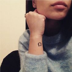 a woman with a small tattoo on her wrist