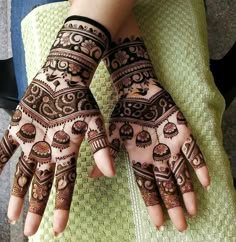 two hands with henna designs on them