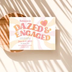 a card with the words dazed and engaged on it sitting next to a wooden plate