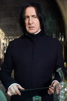 a man with long black hair holding a wand