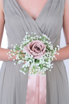 a bridesmaid holding a bouquet of flowers in her hands