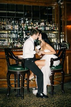 a man and woman sitting at a bar