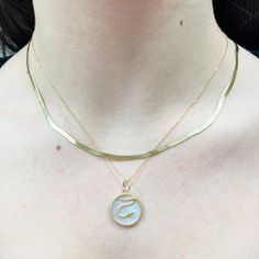 This snake charm represents transformation, healing, and rebirth. Slide it onto any chain for an extra pop to your look.14K Yellow Gold1 Mother of PearlMeasuring: 20 millimeters - 0.78 inch Everyday Snake Shape Box Chain Jewelry, 14k Gold Curb Chain Pendant Necklace, 14k Gold Round Charm Necklaces, Yellow Gold Jewelry With Initial Pendant Box Chain, 14k Gold Initial Pendant Jewelry With Box Chain, Snake Chain Jewelry As Gift, Gold Snake-shaped 14k Gold Necklace, Gold Snake Shape 14k Gold Necklace, 14k Gold Box Chain Charm Necklace