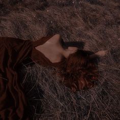 a woman laying on the ground with her head down