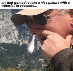 an older man talking on his cell phone in the mountains