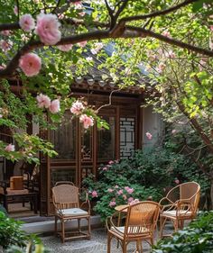 an outdoor patio with chairs and tables surrounded by flowers