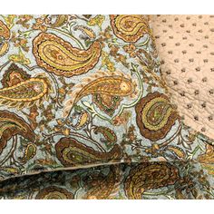 two pillows with paisley designs on them, one is blue and the other is brown