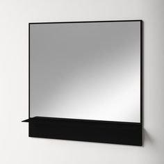 a mirror mounted to the side of a wall