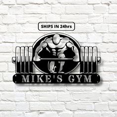 the logo for mike's gym is shown on a brick wall